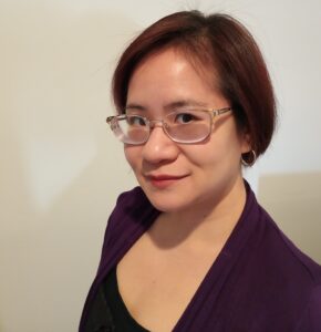 Headshot of Diana Pho: a Vietnamese-American cis woman with a short bob haircut and silver glasses.